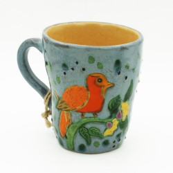 Blue ceramic cup with a bird
